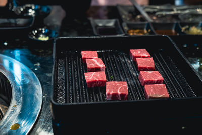 High angle view of meat on barbecue grill