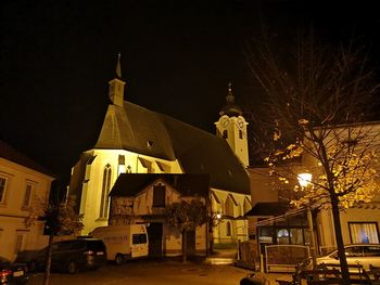Illuminated building against sky at night