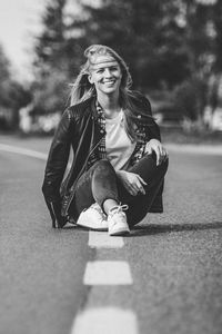 Portrait of a smiling young woman sitting outdoors