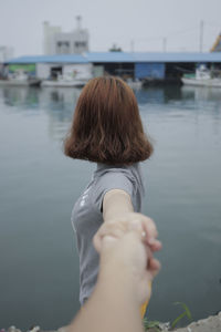 Rear view of woman against sea