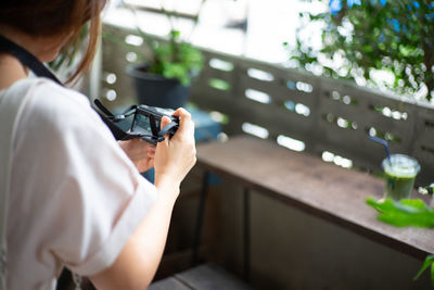 Rear view of woman using mobile phone