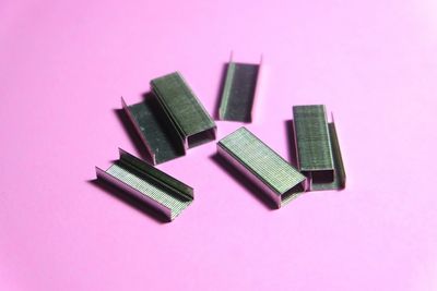 High angle view of pins on pink background 