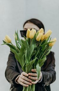 Midsection of woman holding potted plant