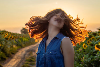 Young woman in sunflower farm