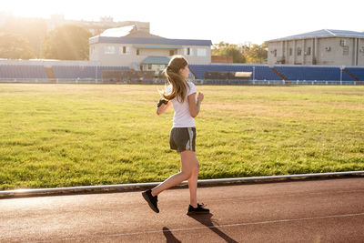 Healthy lifestyle concept. active young woman jogging at the stadium