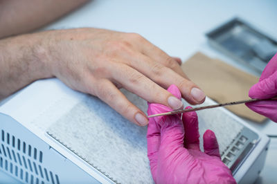 Cropped hands of man working at table