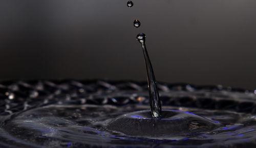 Close-up of water splashing against black background