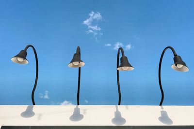 Close-up of lamp against sky