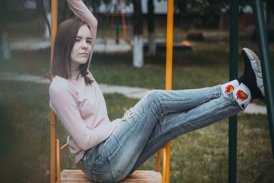 Side view of young woman sitting on seat