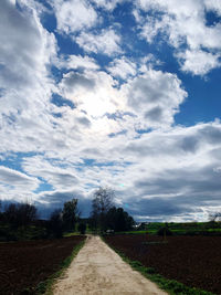 Empty road along countryside landscape