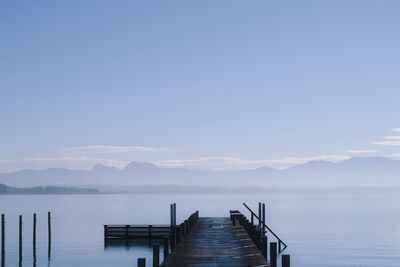 Pier over lake against sky