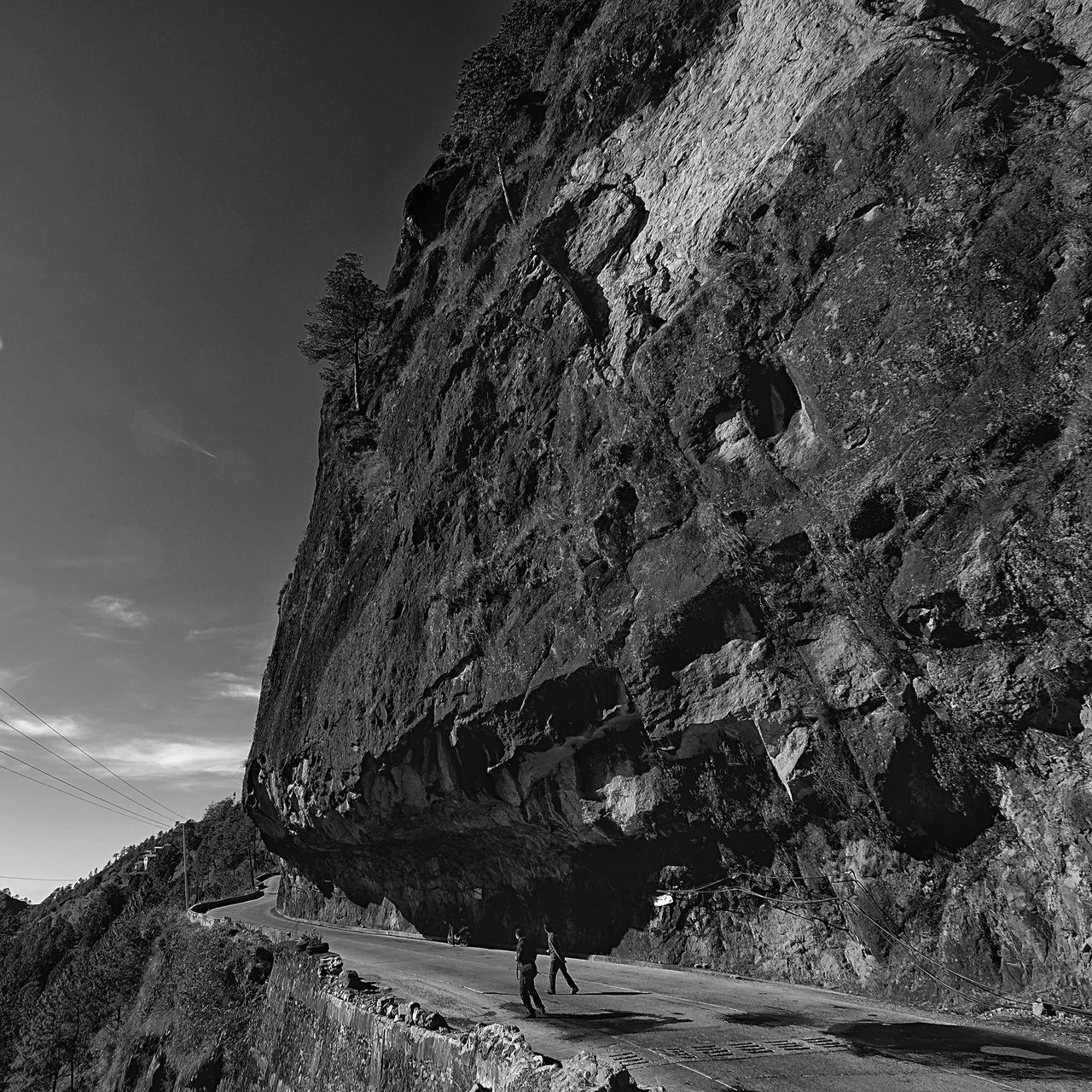 lifestyles, leisure activity, men, person, sky, sunlight, walking, tourist, rock - object, shadow, travel, full length, day, outdoors, built structure, rock formation, vacations