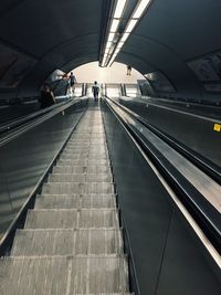 High angle view of people on escalators at subway station