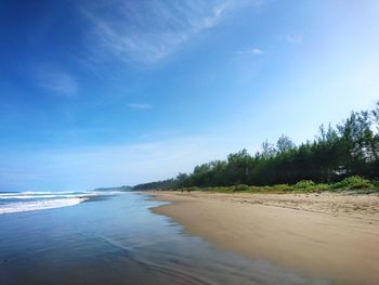 Scenic view of beach against blue sky