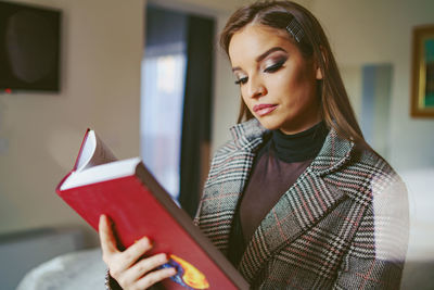 Young woman looking at book
