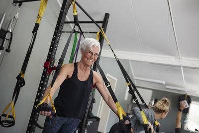 Woman using training equipment in gym