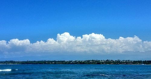 Scenic view of sea against blue sky