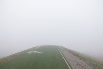 Road in foggy weather against sky