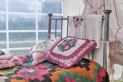 Traditional decor of bed in tatar vintage style. woven bedspread, pillows embroidered with ribbons