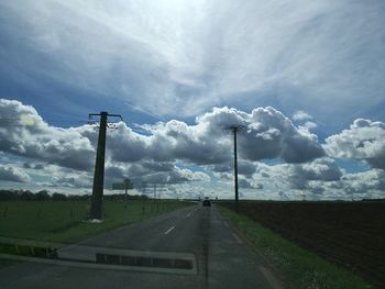 Street amidst road against sky