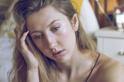 Close-up portrait of young woman at home