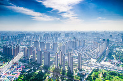 High angle view of cityscape against cloudy sky