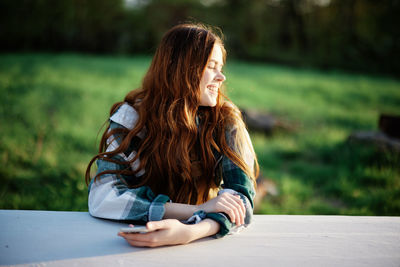 Young woman sitting on table