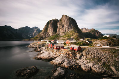 Scenic view of rocks by sea against sky