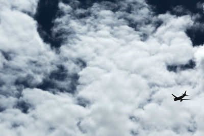 Low angle view of airplane flying in sky