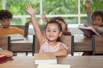 Cute students at desks in classroom