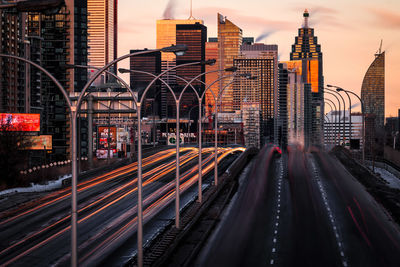 Blurred motion of train in city against sky