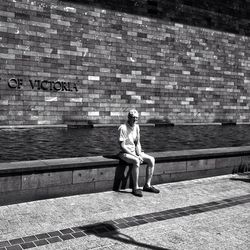 Full length of man standing on wall