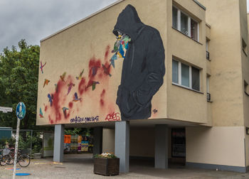 Man standing against multi colored building