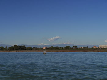 Scenic view of sea against clear blue sky