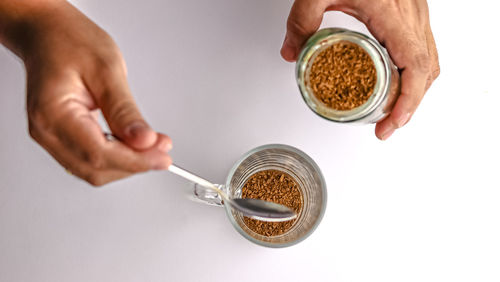 Cropped image of man holding coffee on table