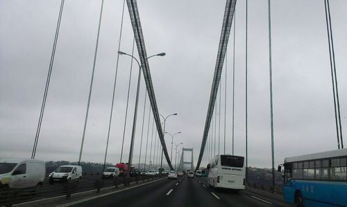 Traffic on road in city against sky
