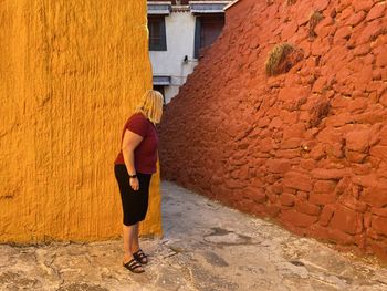 Full length side view of woman with colored walls