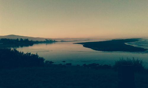 Scenic view of sea against clear sky during sunset