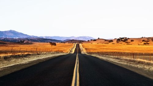 Country road leading towards mountains