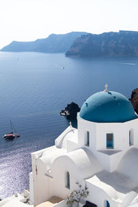 Oia, santorini. white church with a blue dome.