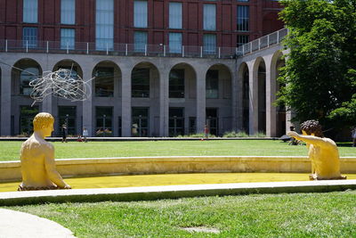 Rear view of woman sitting outside building