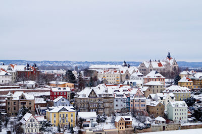 Snow covered meissen townscape against sky during winter