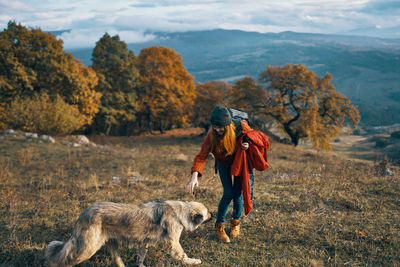 Full length of man with dog on land