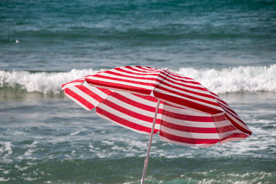 Red flag on sea shore