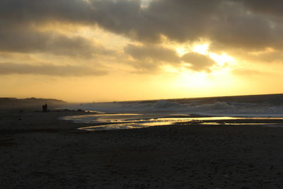 Scenic view of beach against sky during sunset