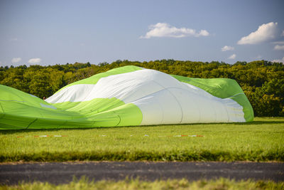 Scenic view of tent on field against sky