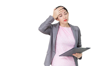 Woman standing against white background