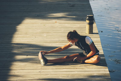 Young woman stretching, uppsala, sweden