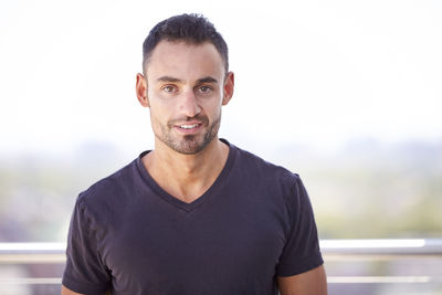 An outdoor portrait of a man in his early thirties.