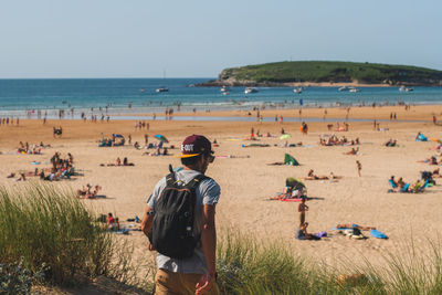 People on beach against clear sky